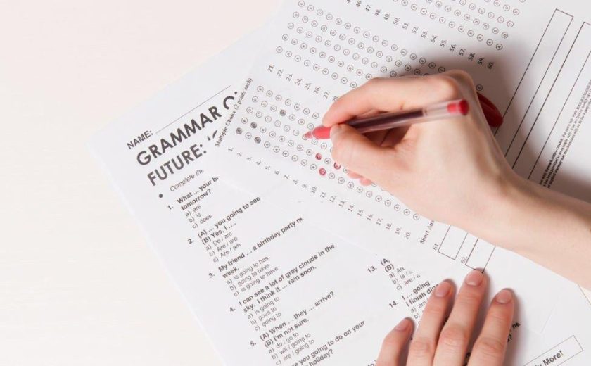 Test of English multiple choice on table.Woman takes an entrance exam.